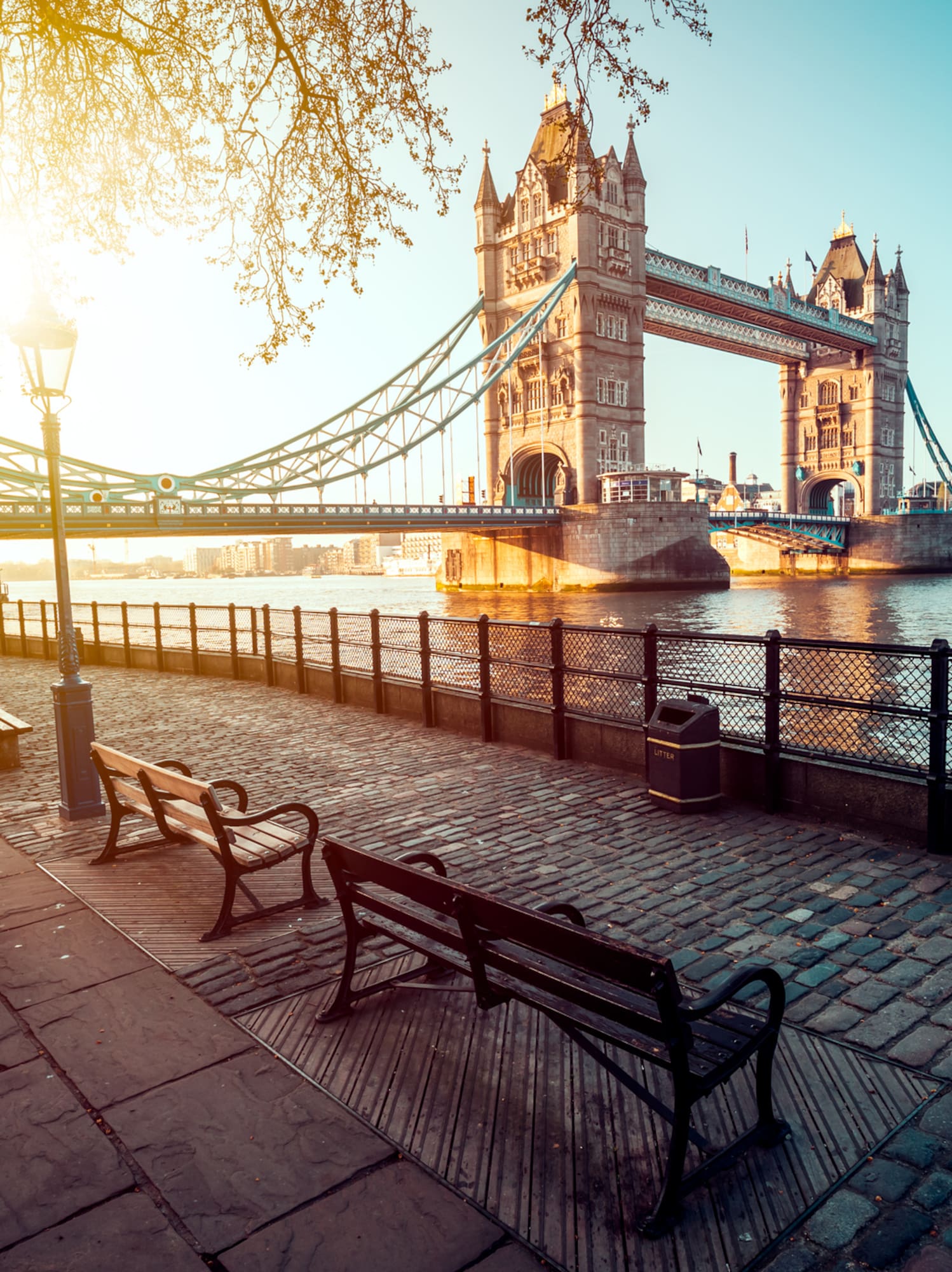 a bridge over water with benches and a bench