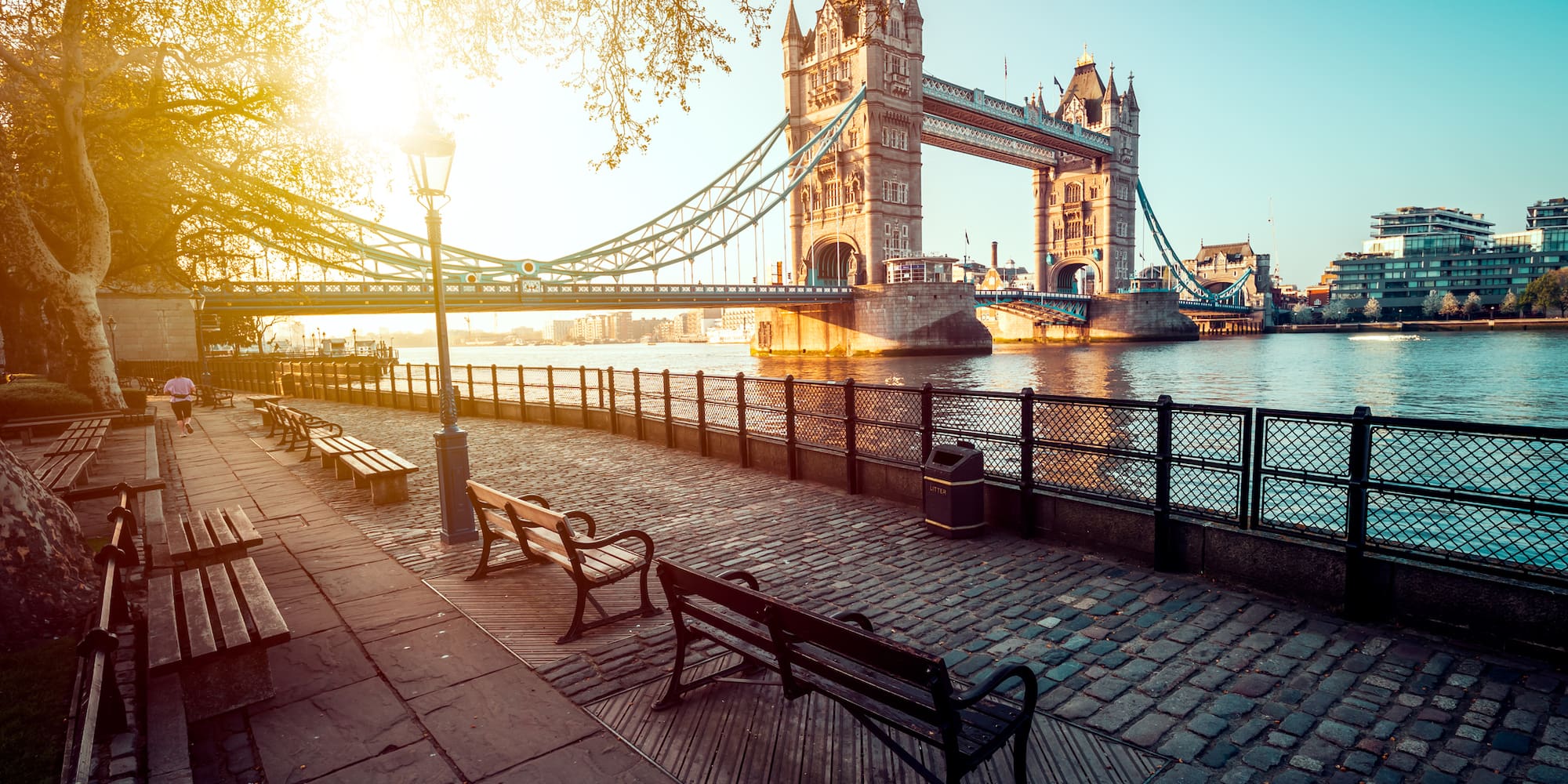 a bridge over water with benches and a bench