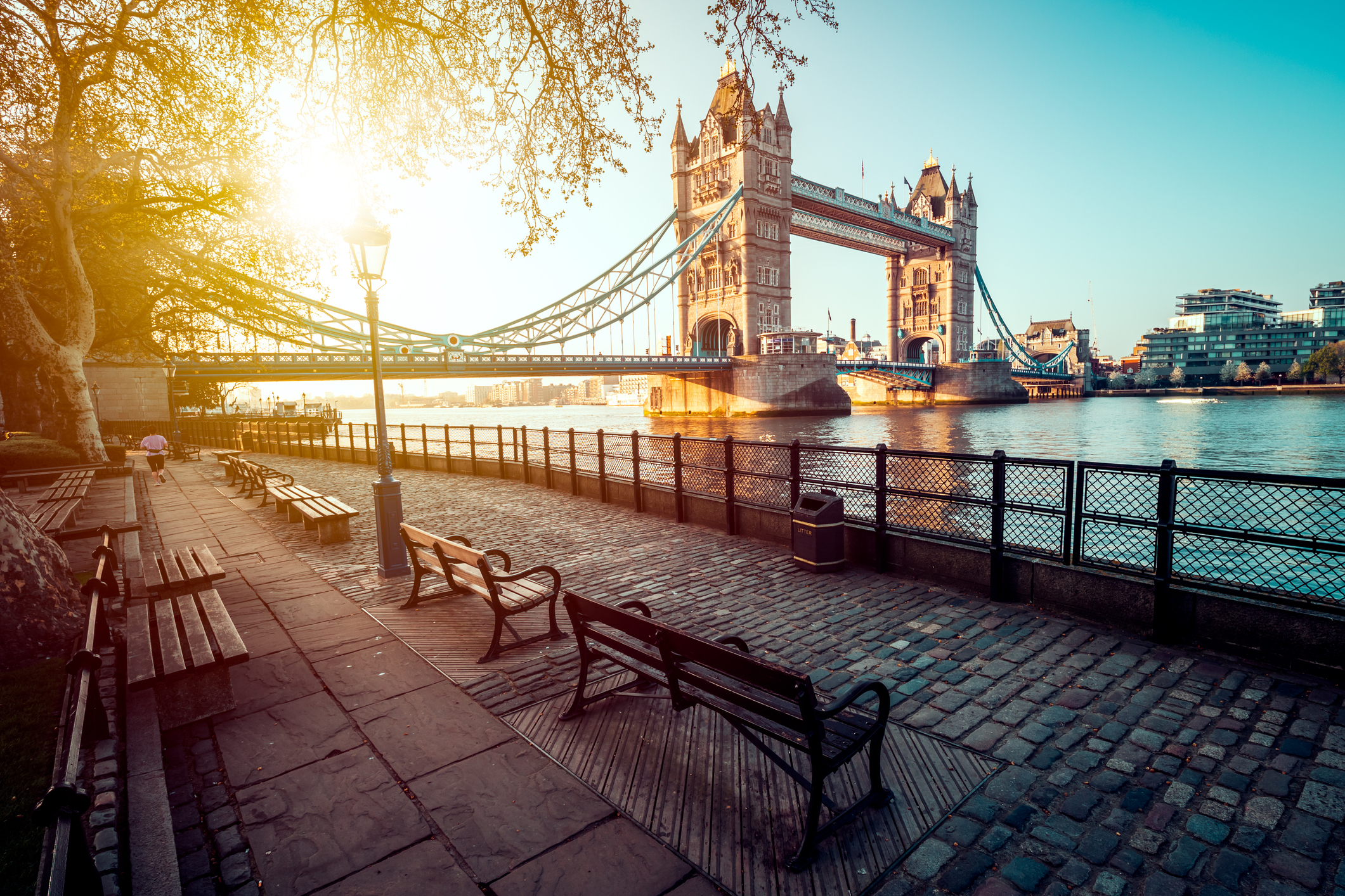 a bridge over water with benches and a bench