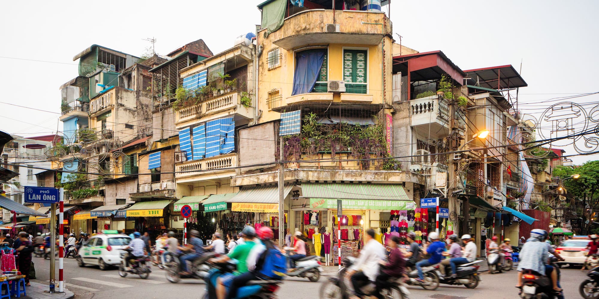 a group of people on motorcycles in a busy city street