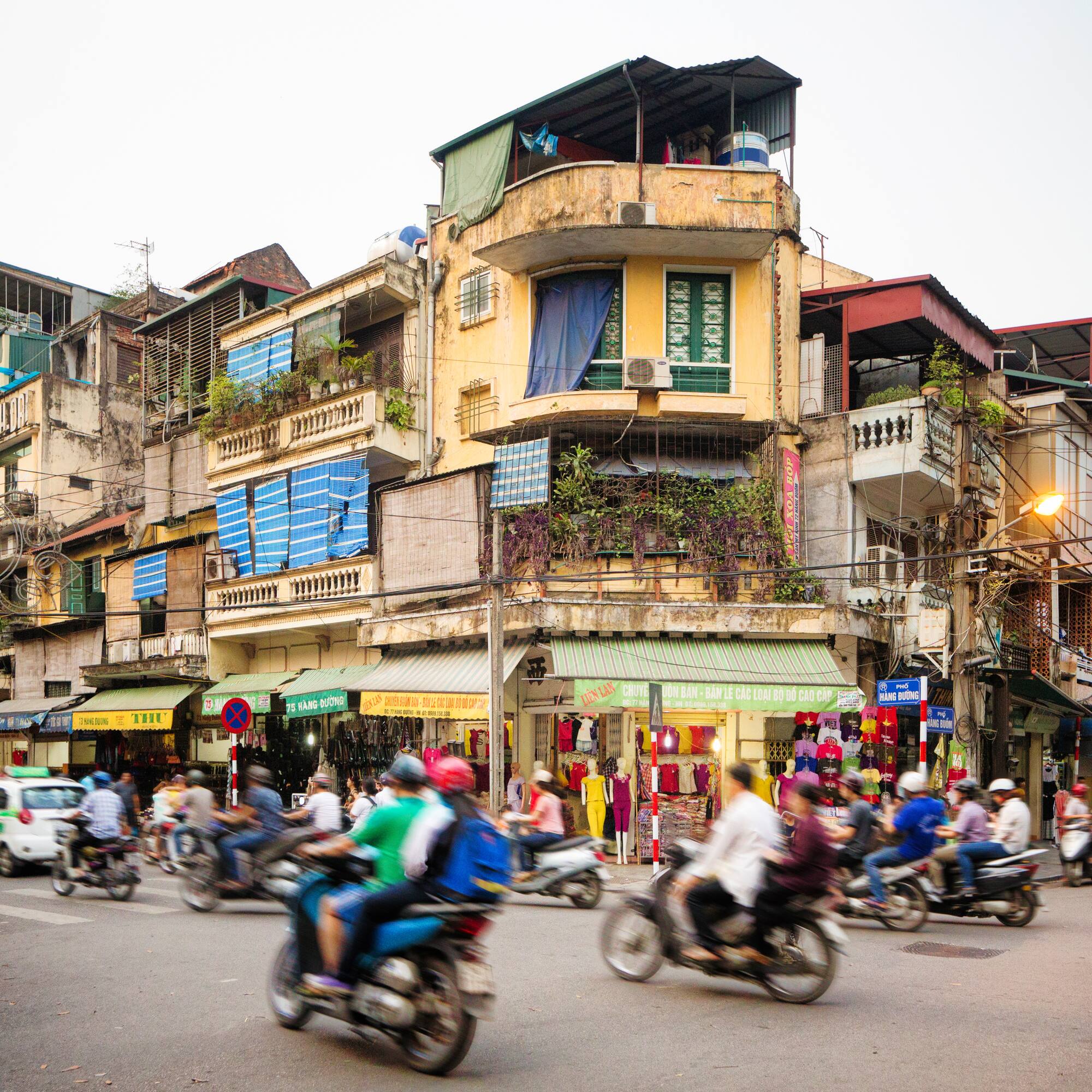 a group of people on motorcycles in a busy city street