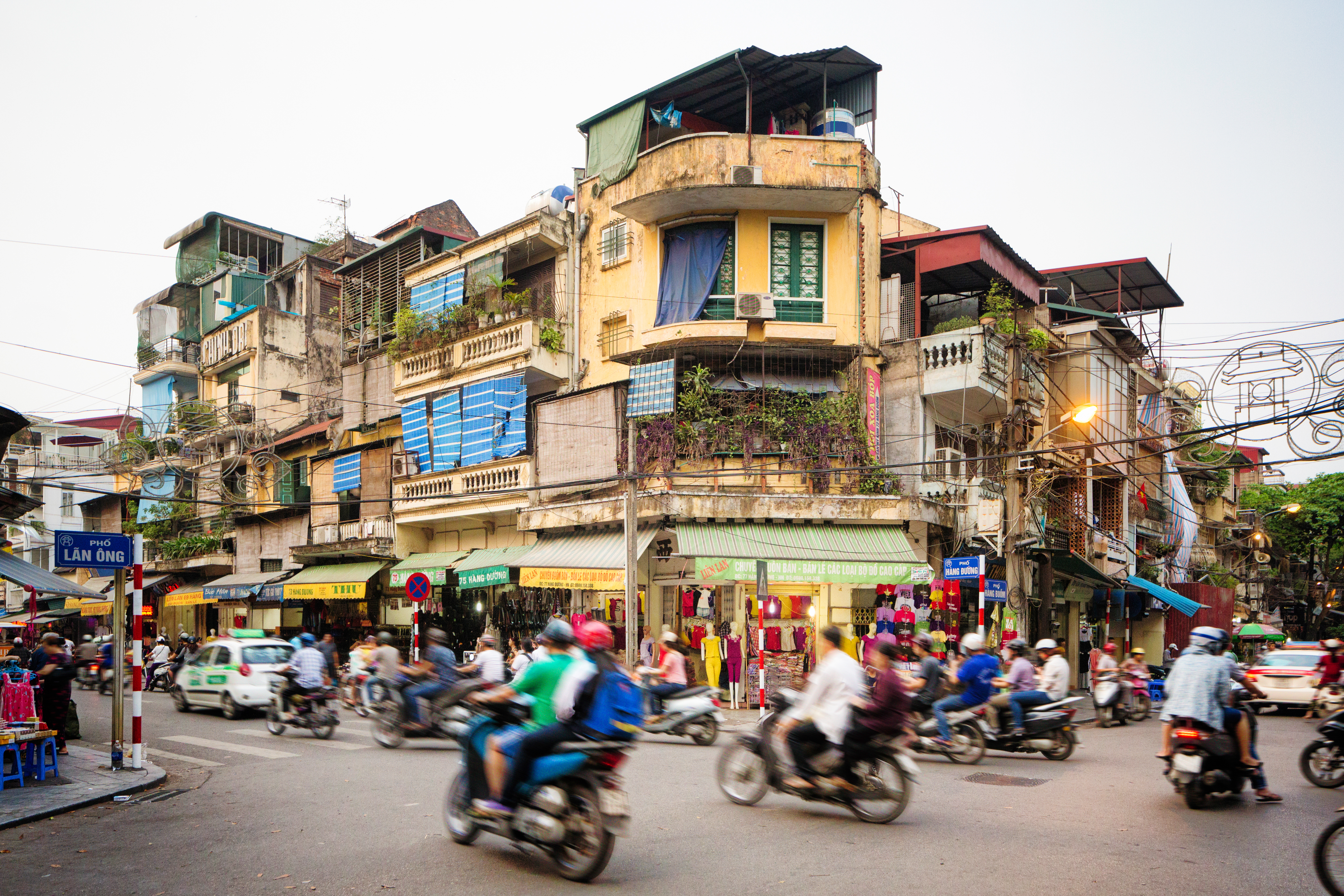 a group of people on motorcycles in a busy city street