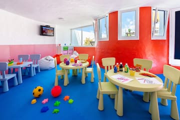 a room with a table and chairs and toys