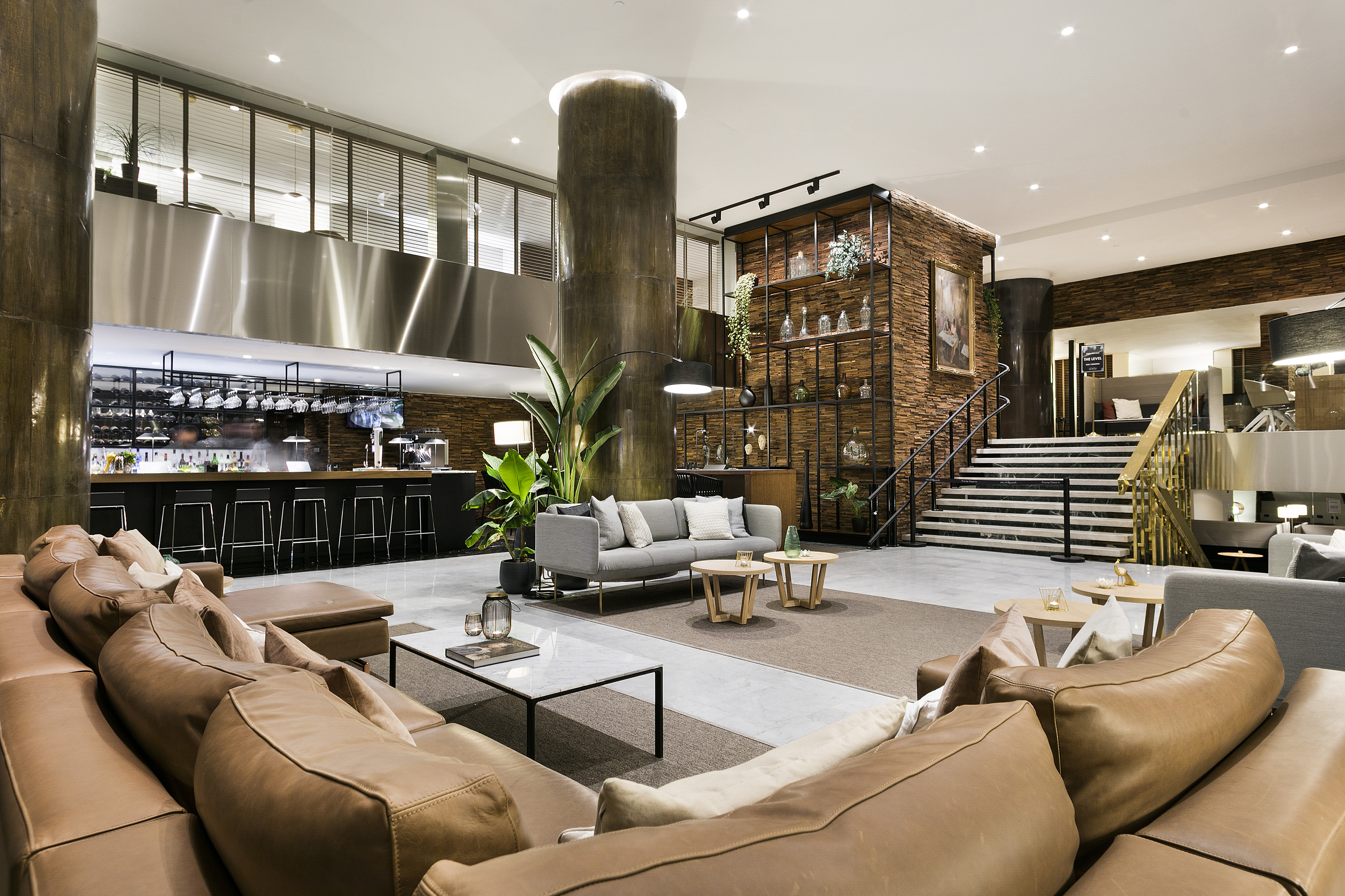 Modern hotel lobby lounge with stylish bar and comfortable seating areas.