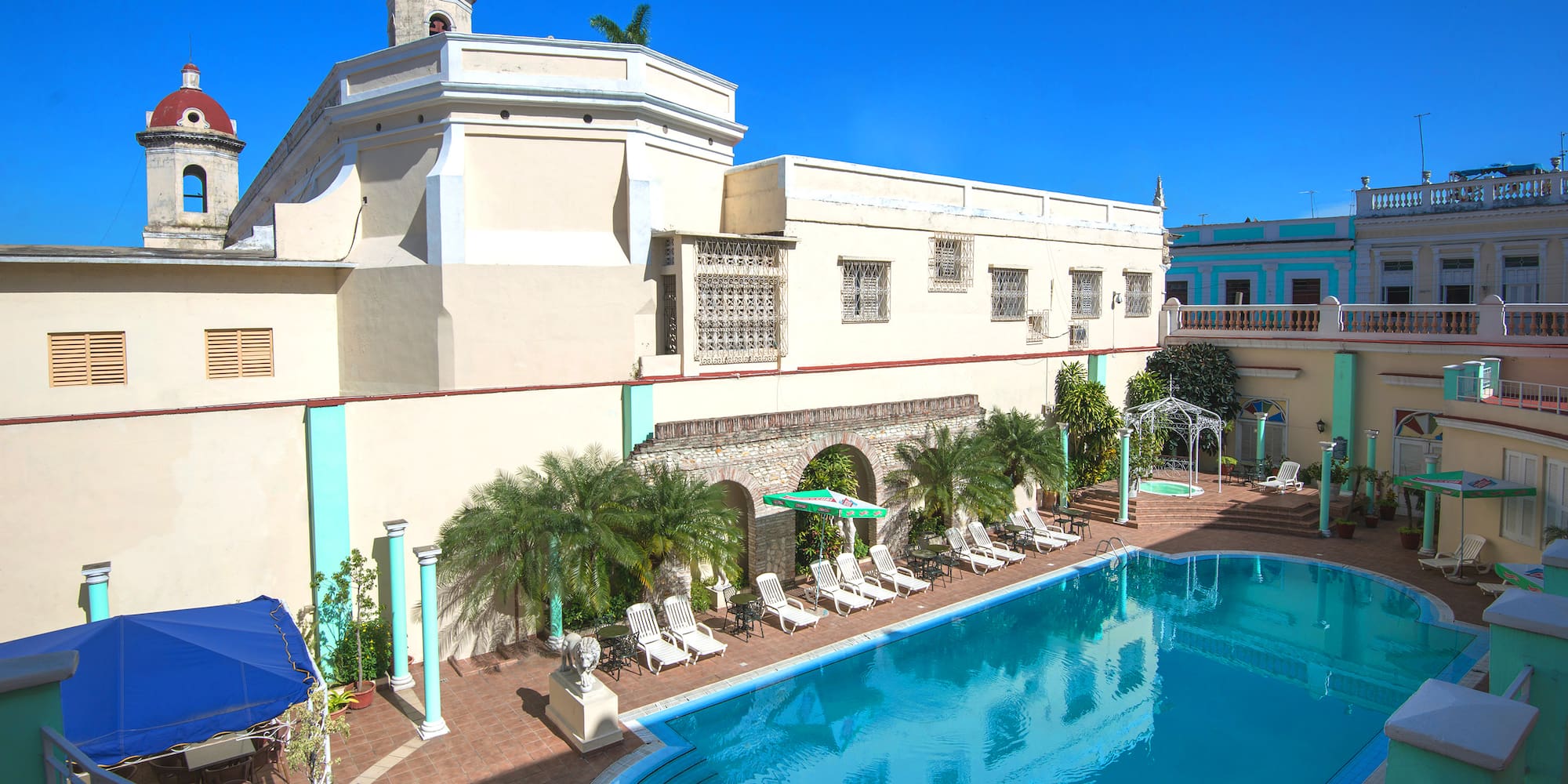 a pool with chairs and a building