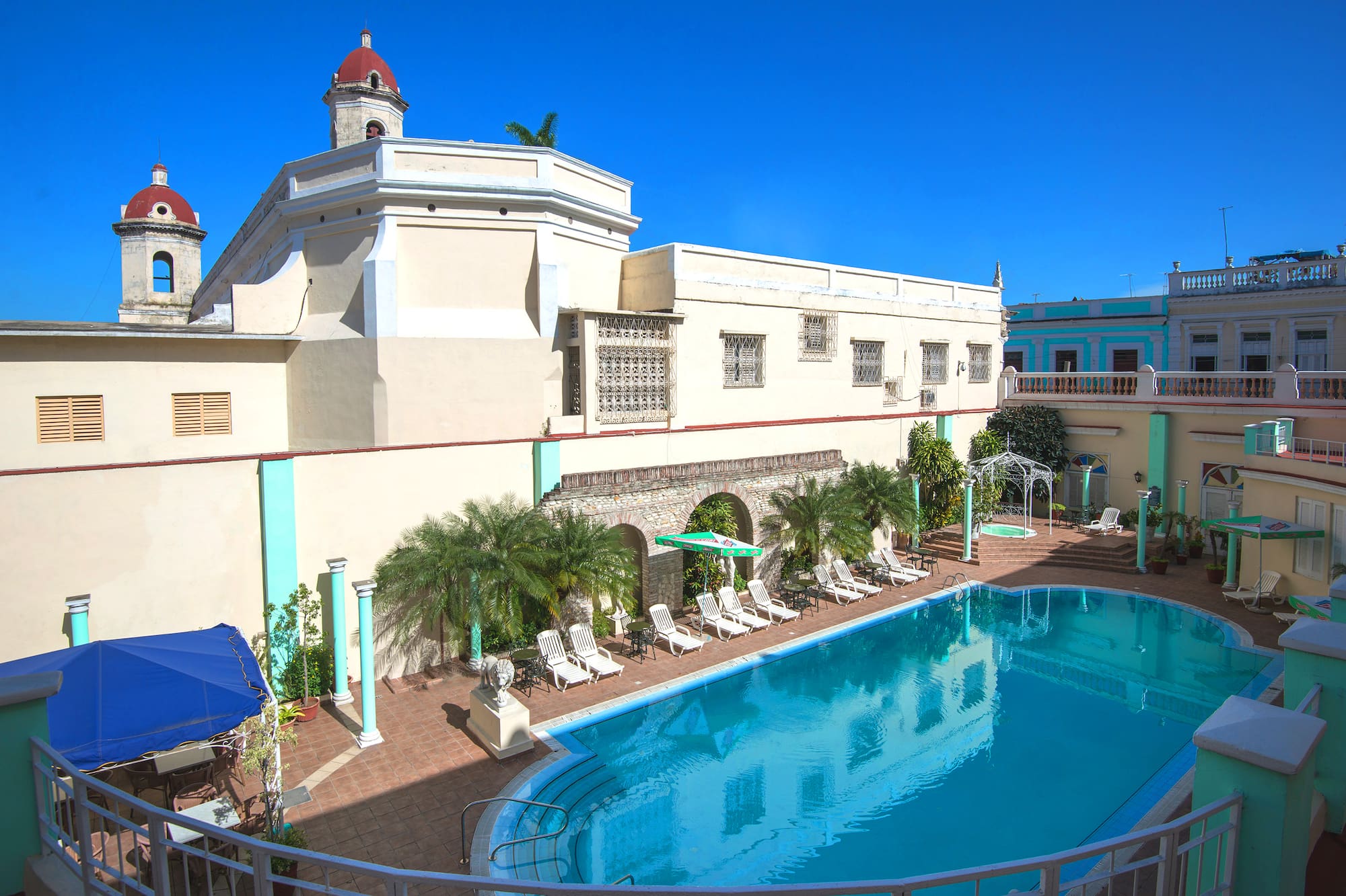 a pool with chairs and a building