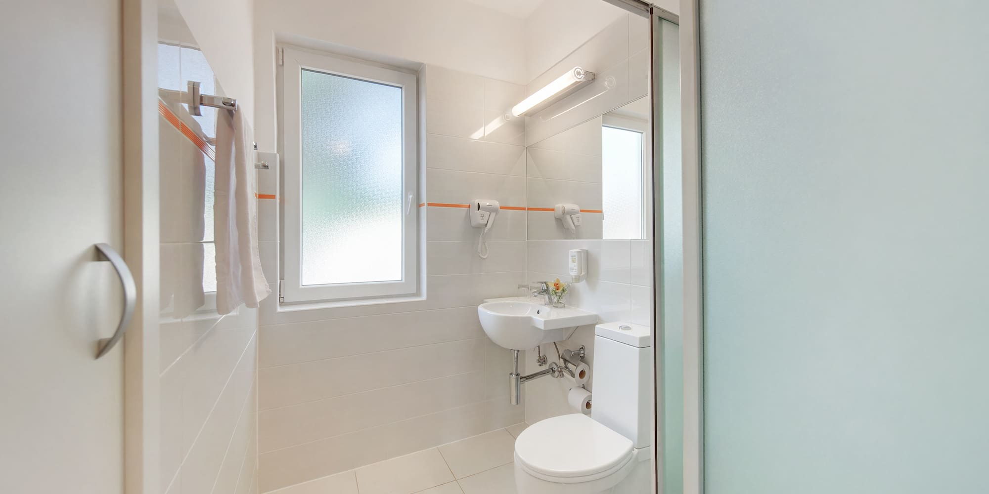 a bathroom with a shower and toilet