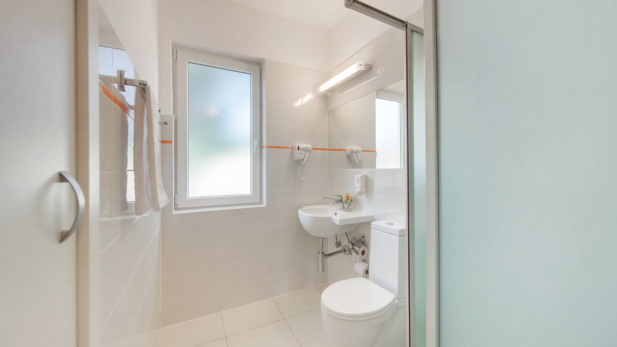 a bathroom with a shower and toilet