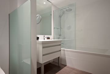 a bathroom with a shower and sink