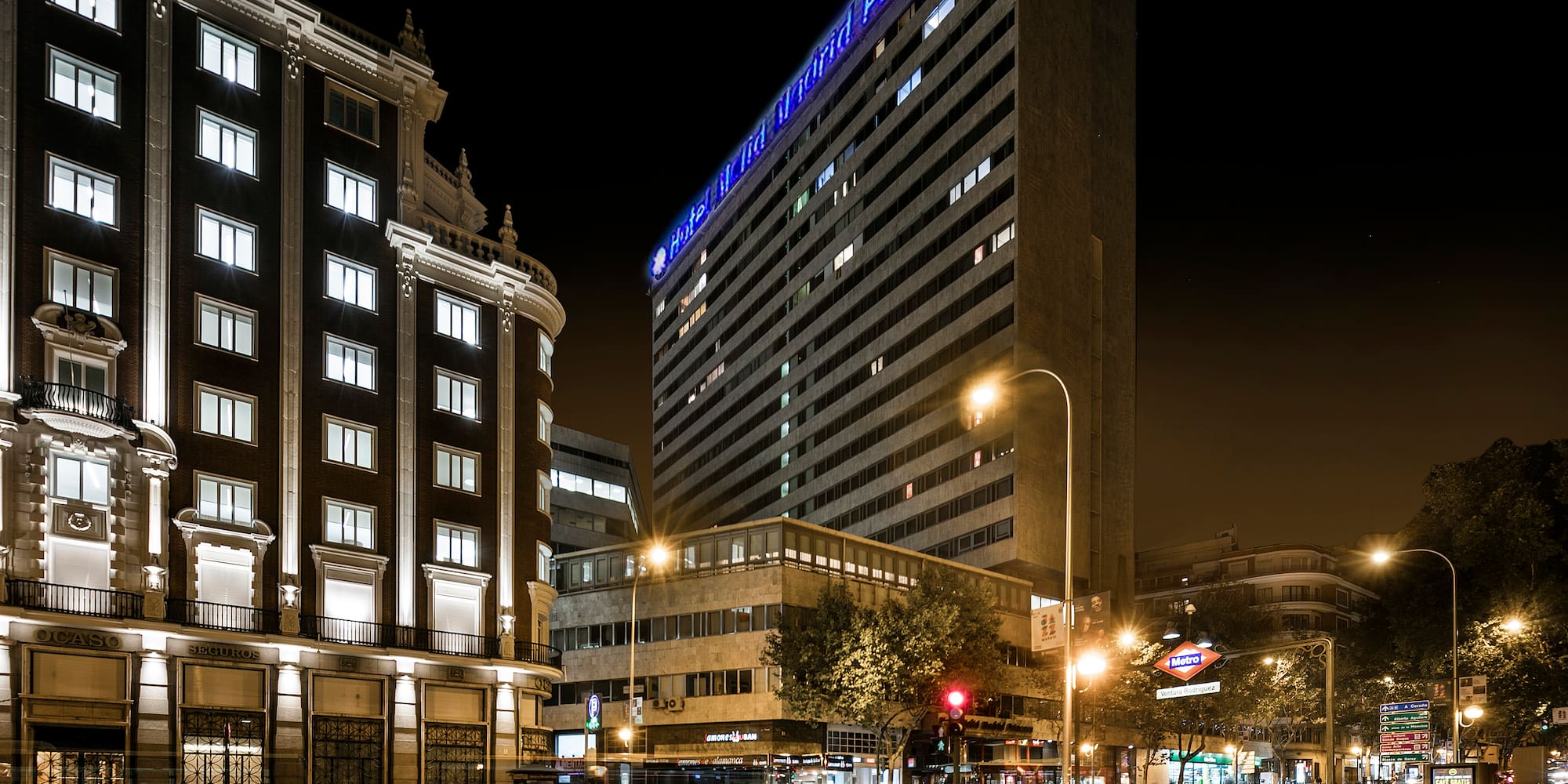 a city street with buildings at night