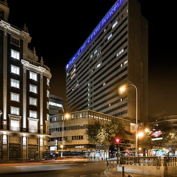 a city street with buildings at night