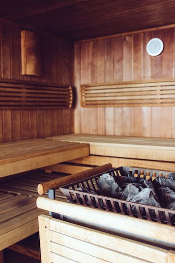 a wood sauna with a basket of coal