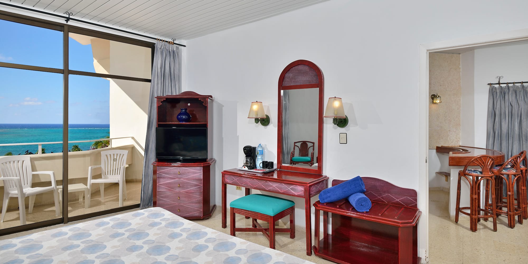 a bedroom with a mirror and a dresser