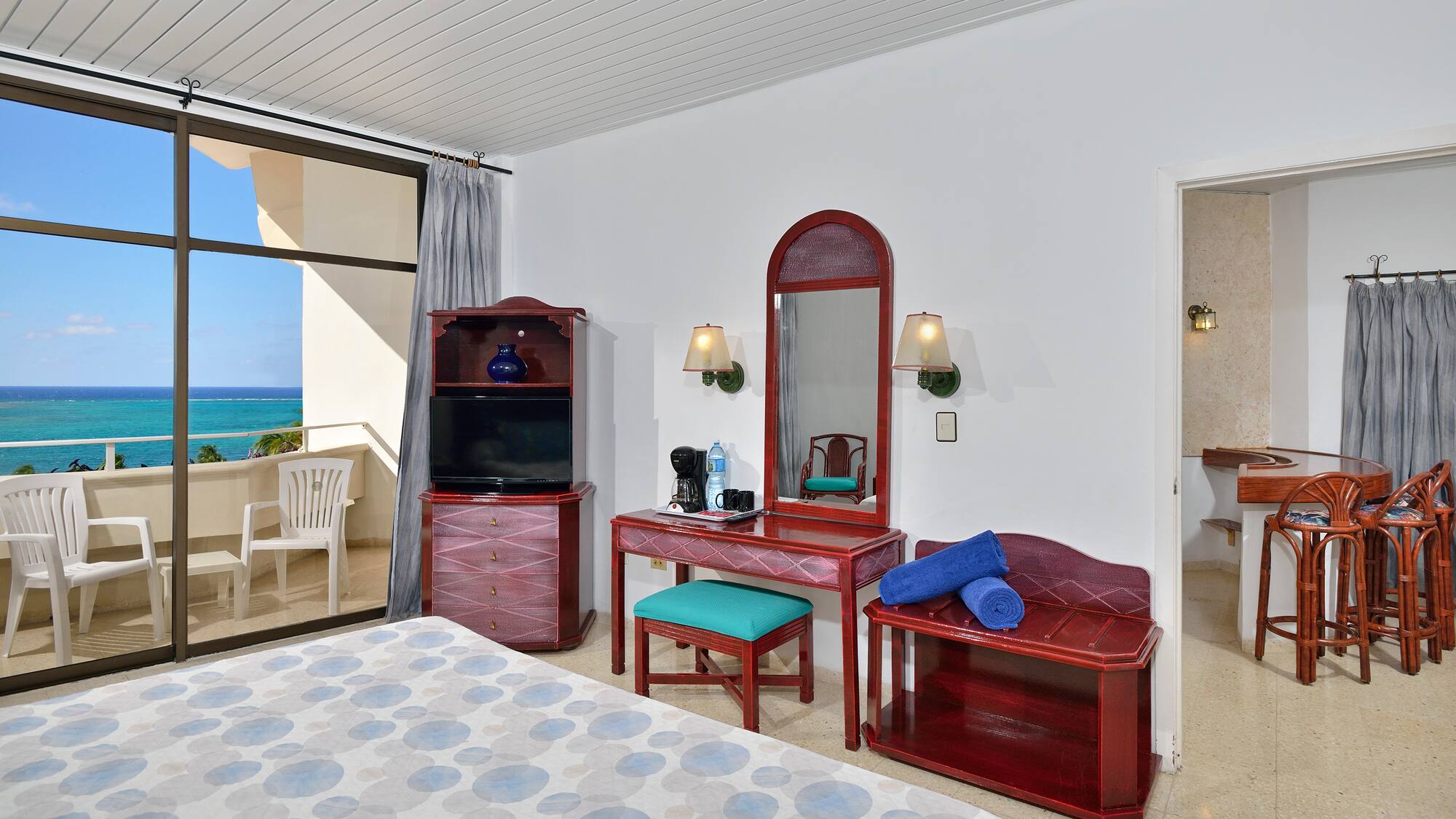 a bedroom with a mirror and a dresser