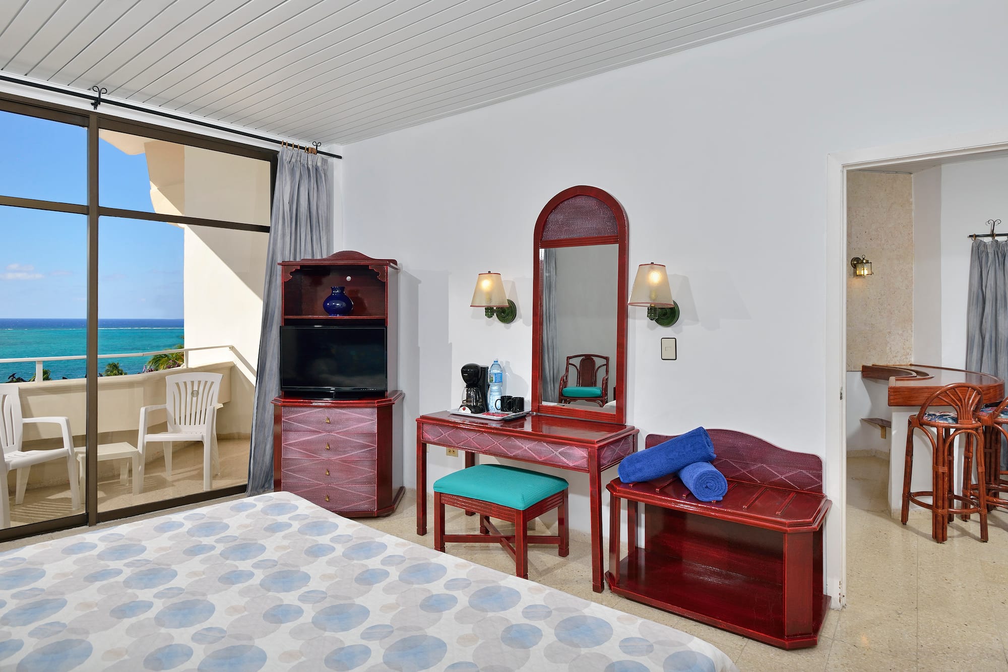 a bedroom with a mirror and a dresser