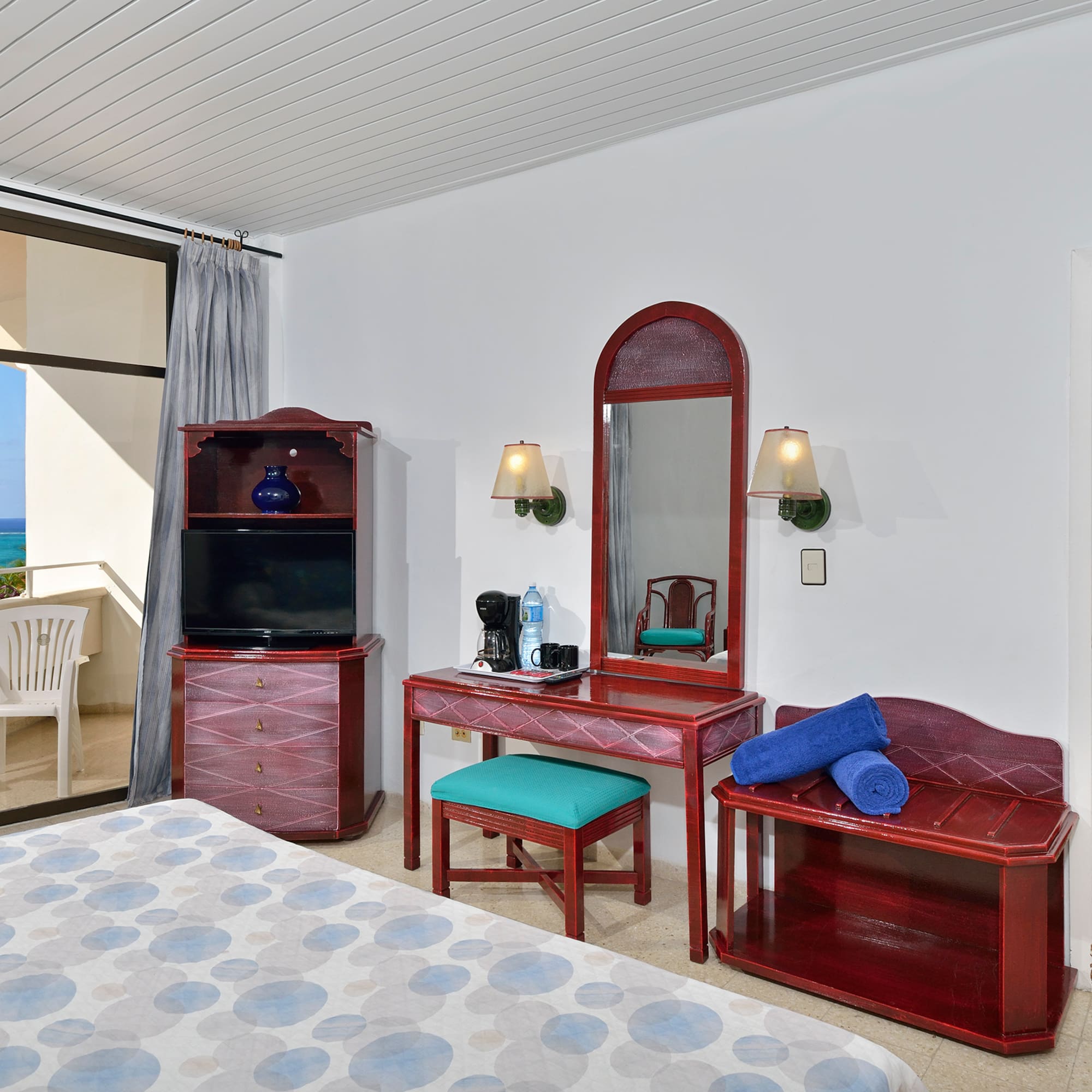 a bedroom with a mirror and a dresser