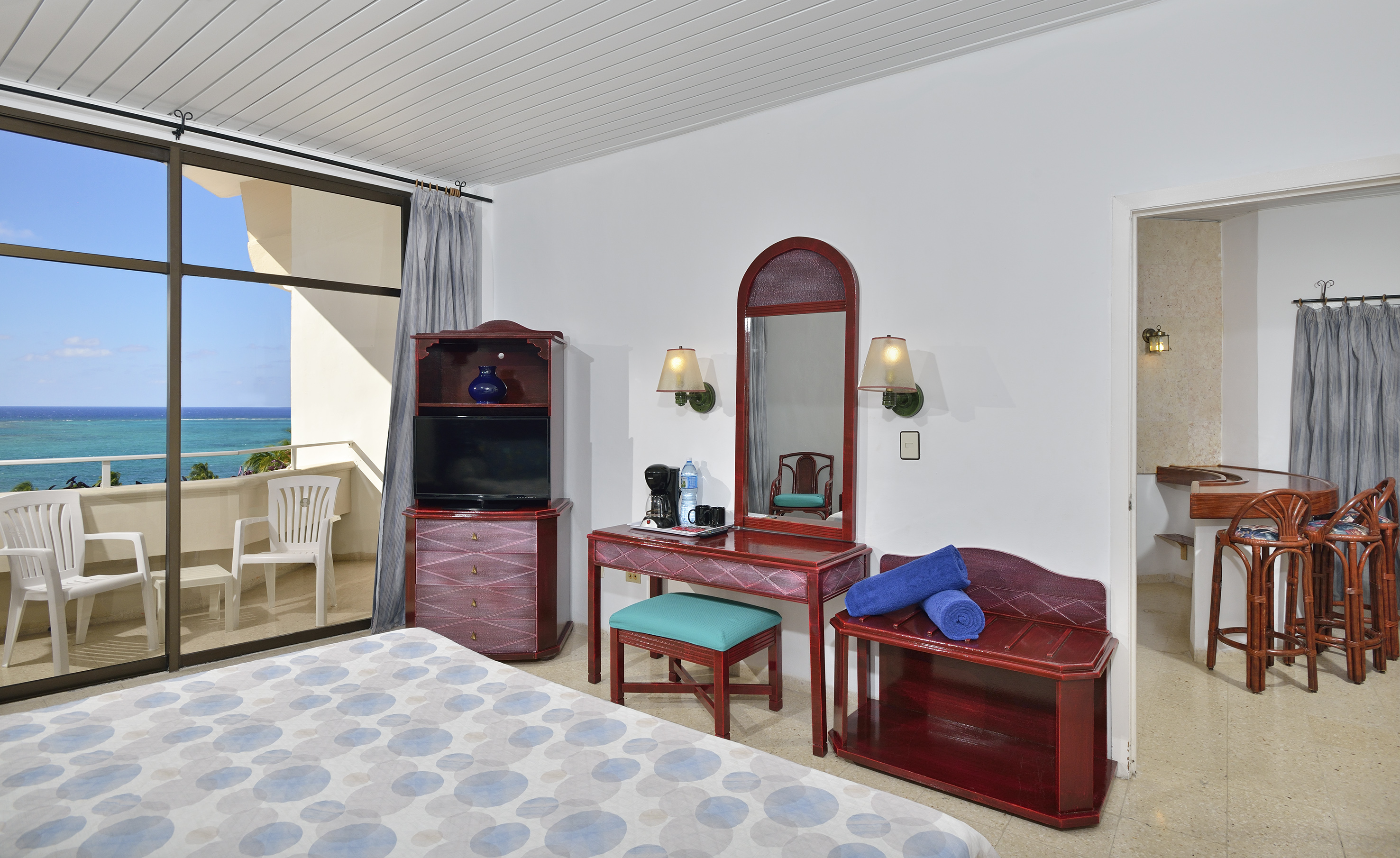 a bedroom with a mirror and a dresser