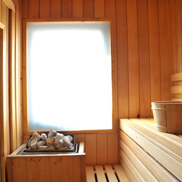 a sauna with a bucket and rocks