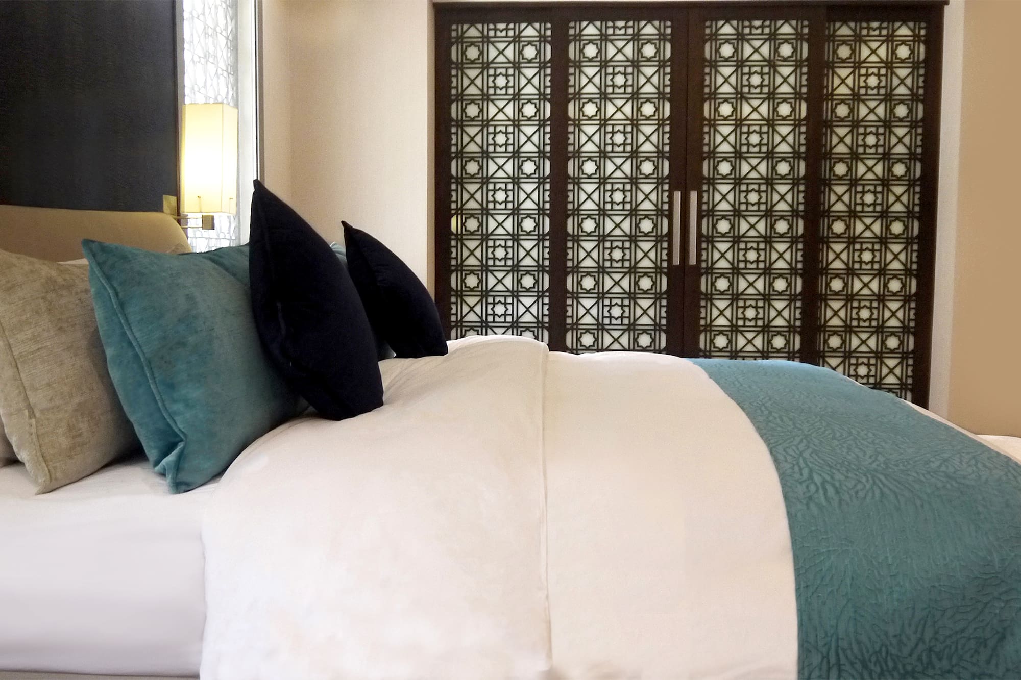 a bed with a blue and white blanket