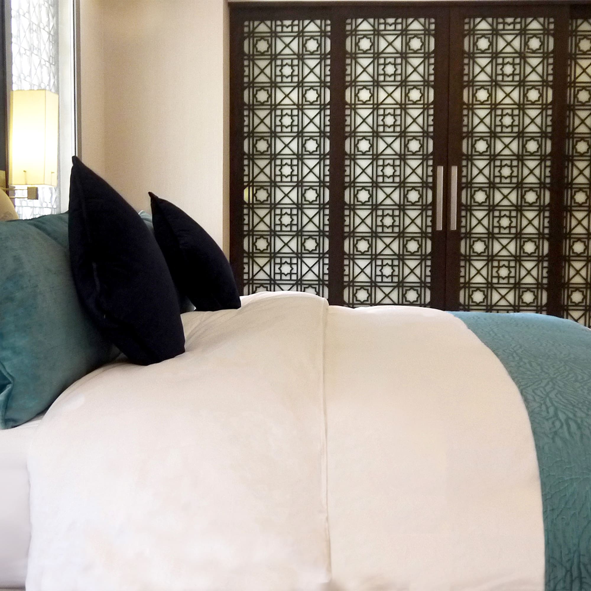 a bed with a blue and white blanket