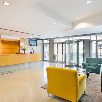 a lobby with a reception desk and chairs