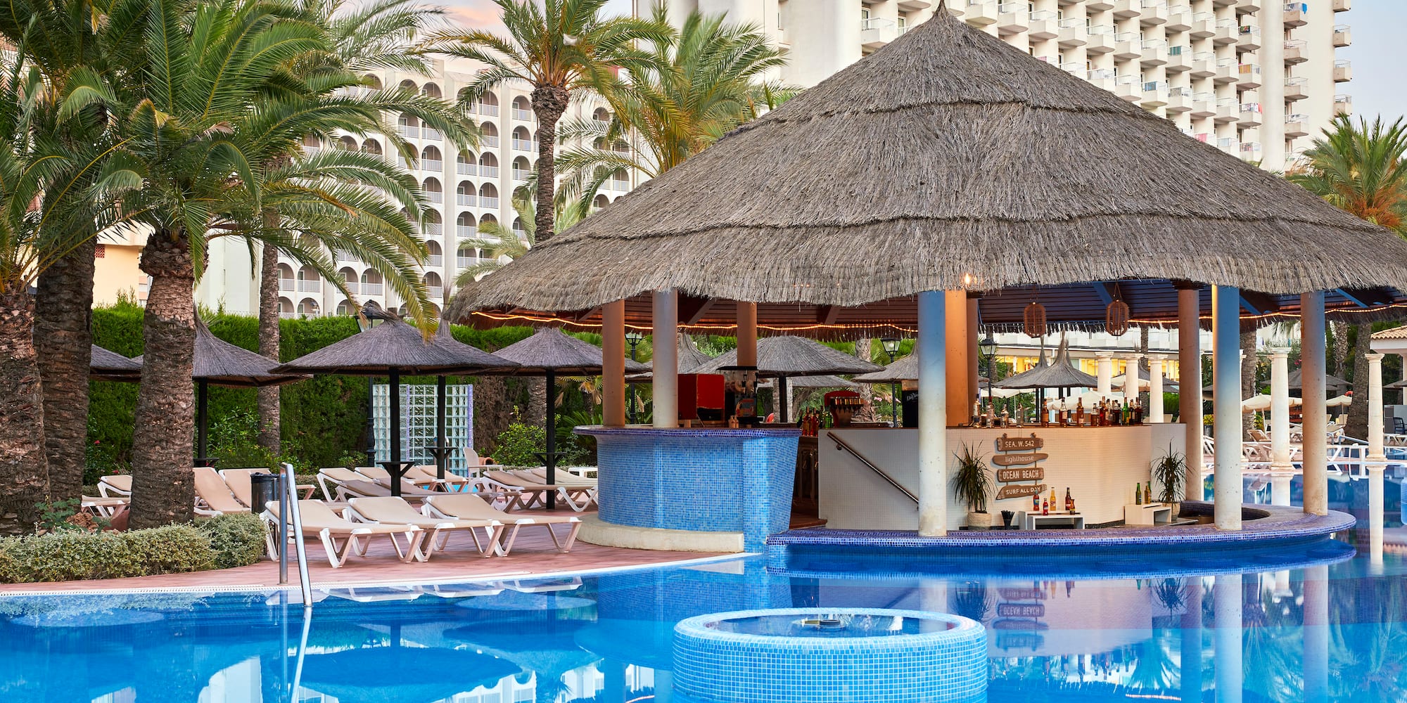 a pool with a bar and a bar in the background