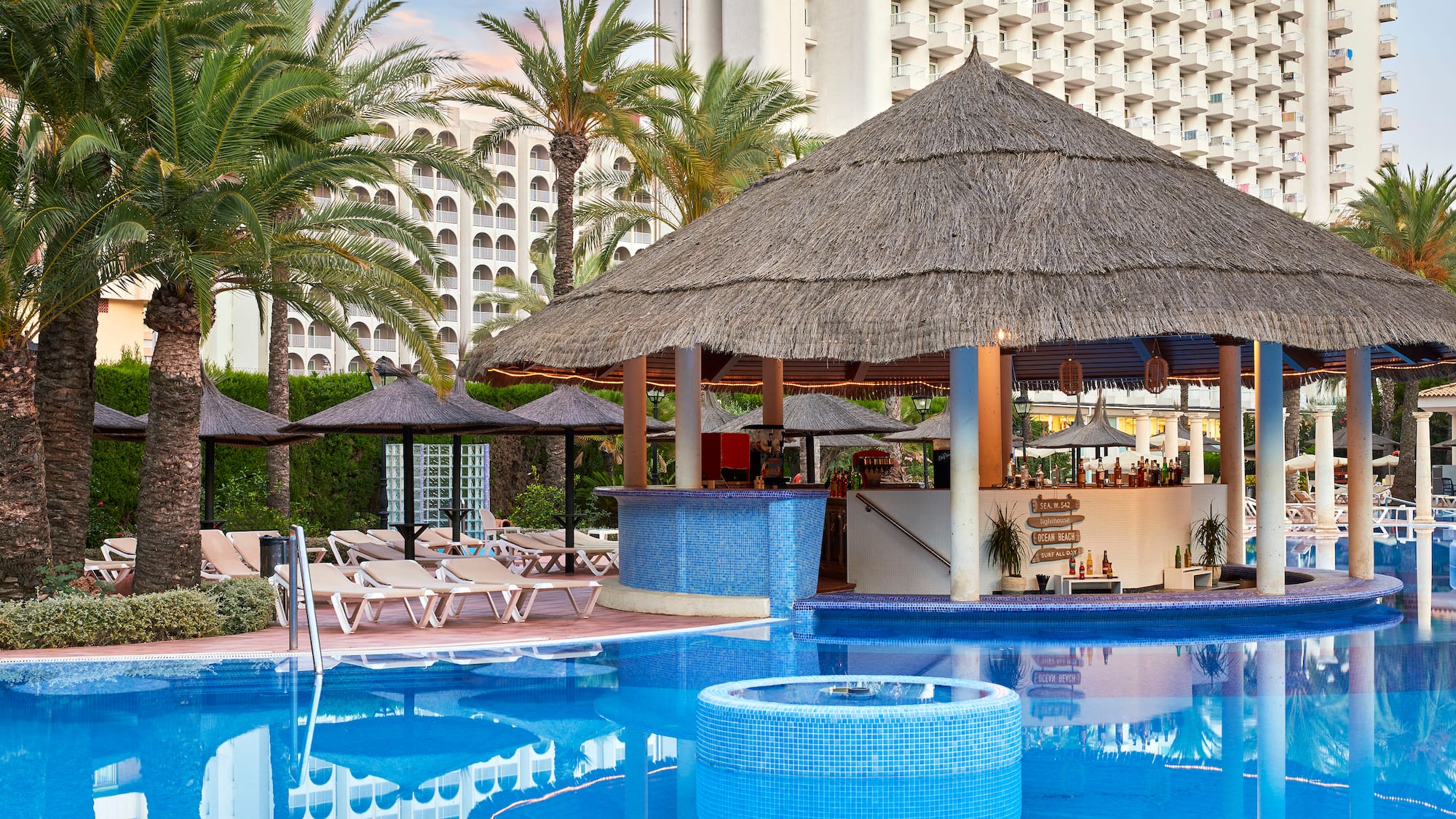 a pool with a bar and a bar in the background