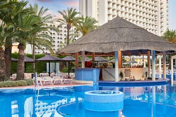 a pool with a bar and a bar in the background