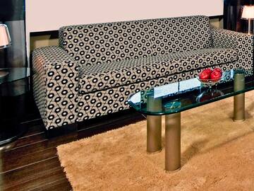 a couch with a glass coffee table