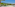 a beach with palm trees and people on it