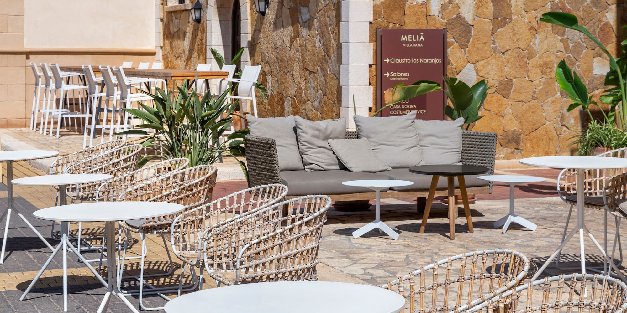 a patio with chairs and tables
