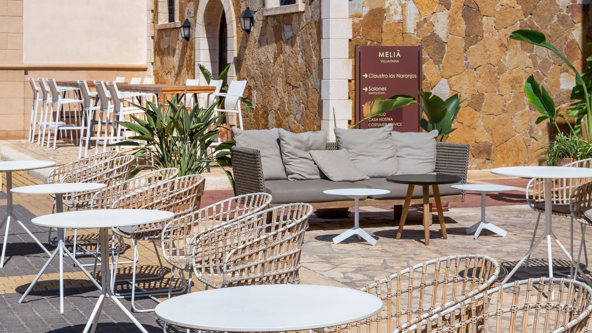 a patio with chairs and tables