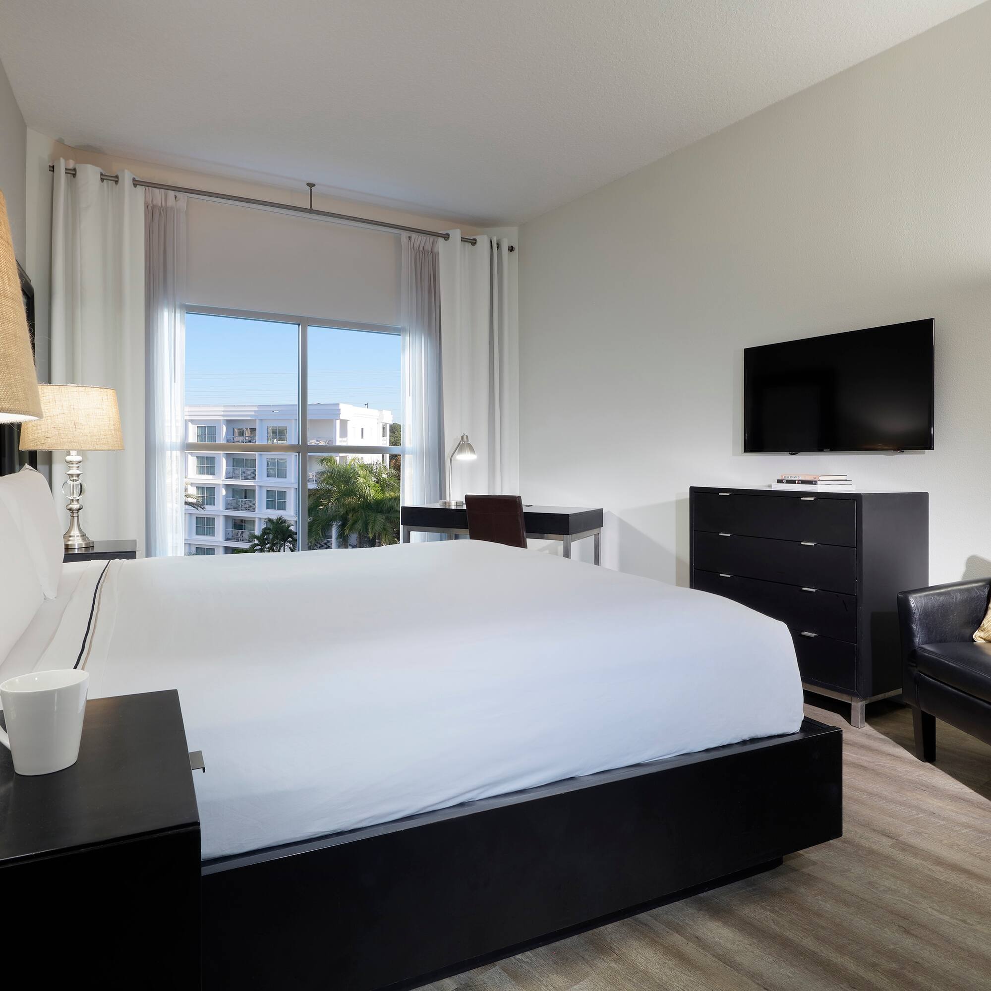 a bedroom with a bed and a television