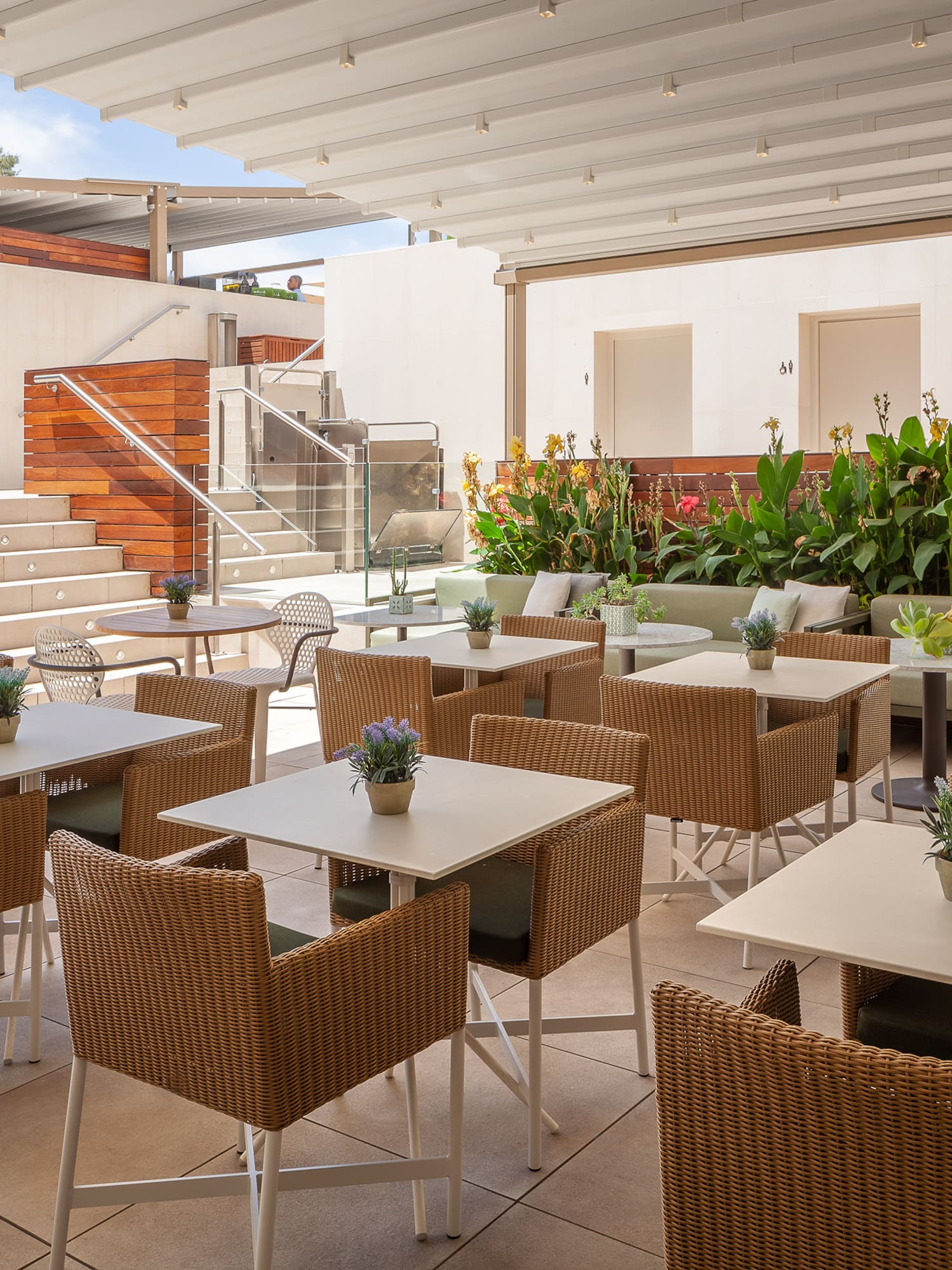 a patio with tables and chairs