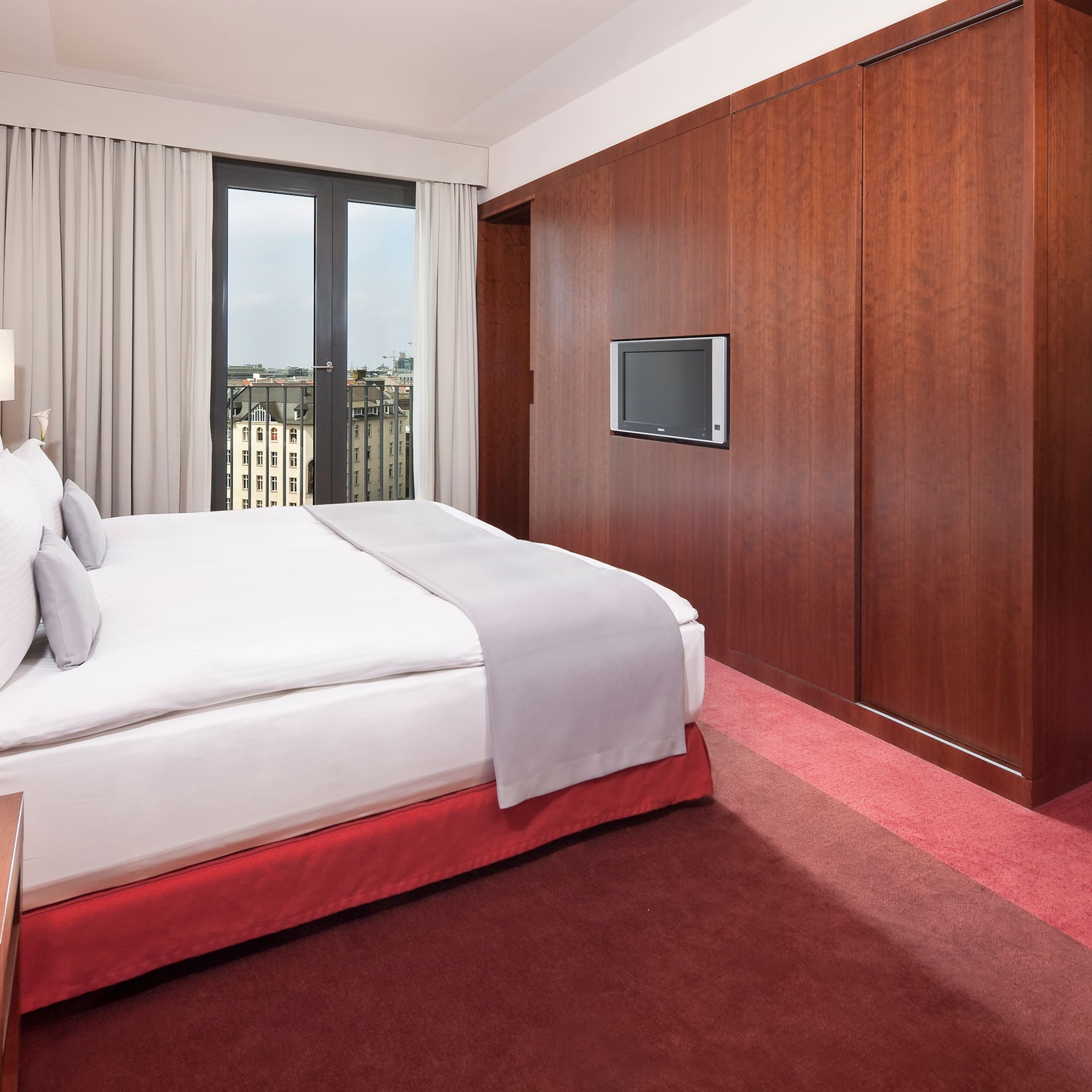 a bedroom with a large bed and a television