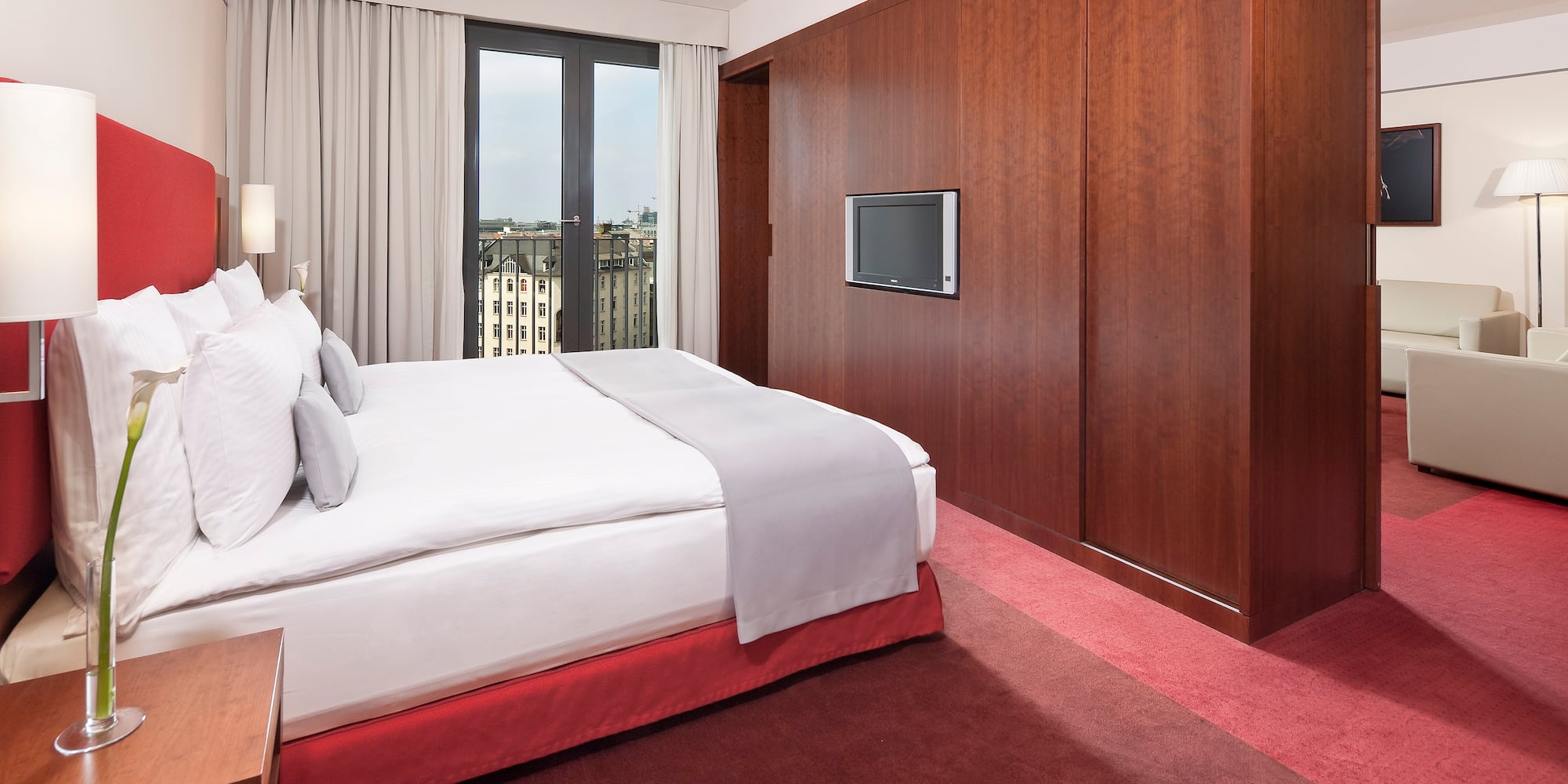 a bedroom with a large bed and a television