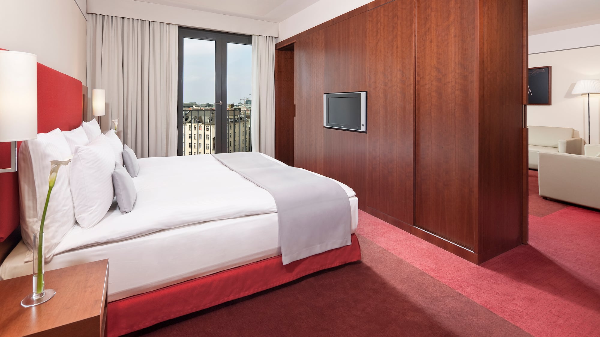 a bedroom with a large bed and a television