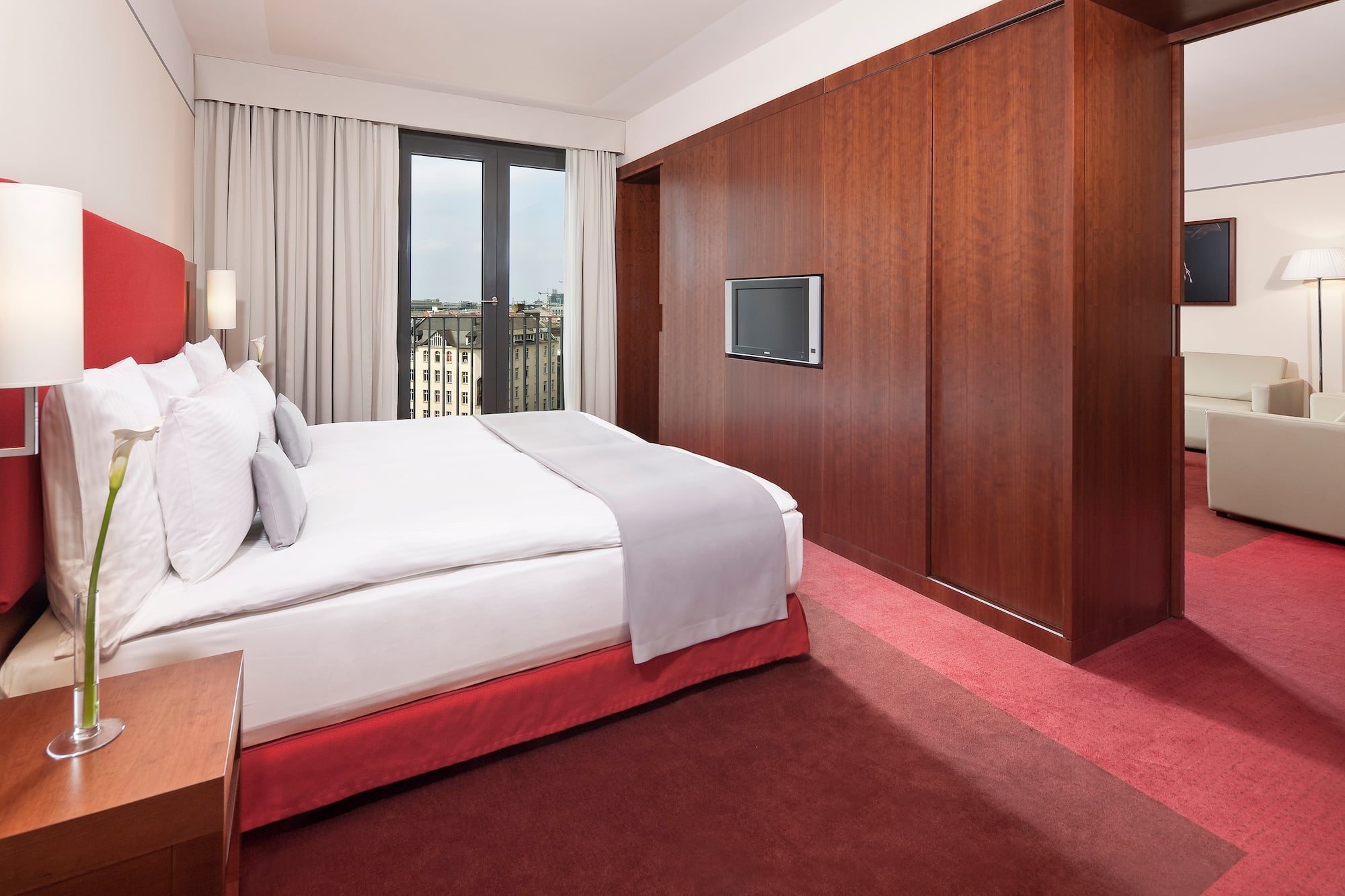 a bedroom with a large bed and a television