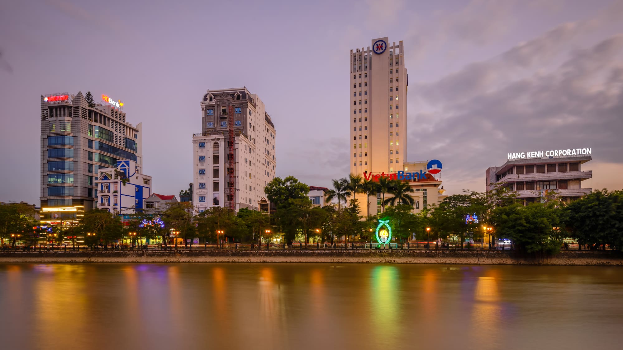 a body of water with buildings and trees