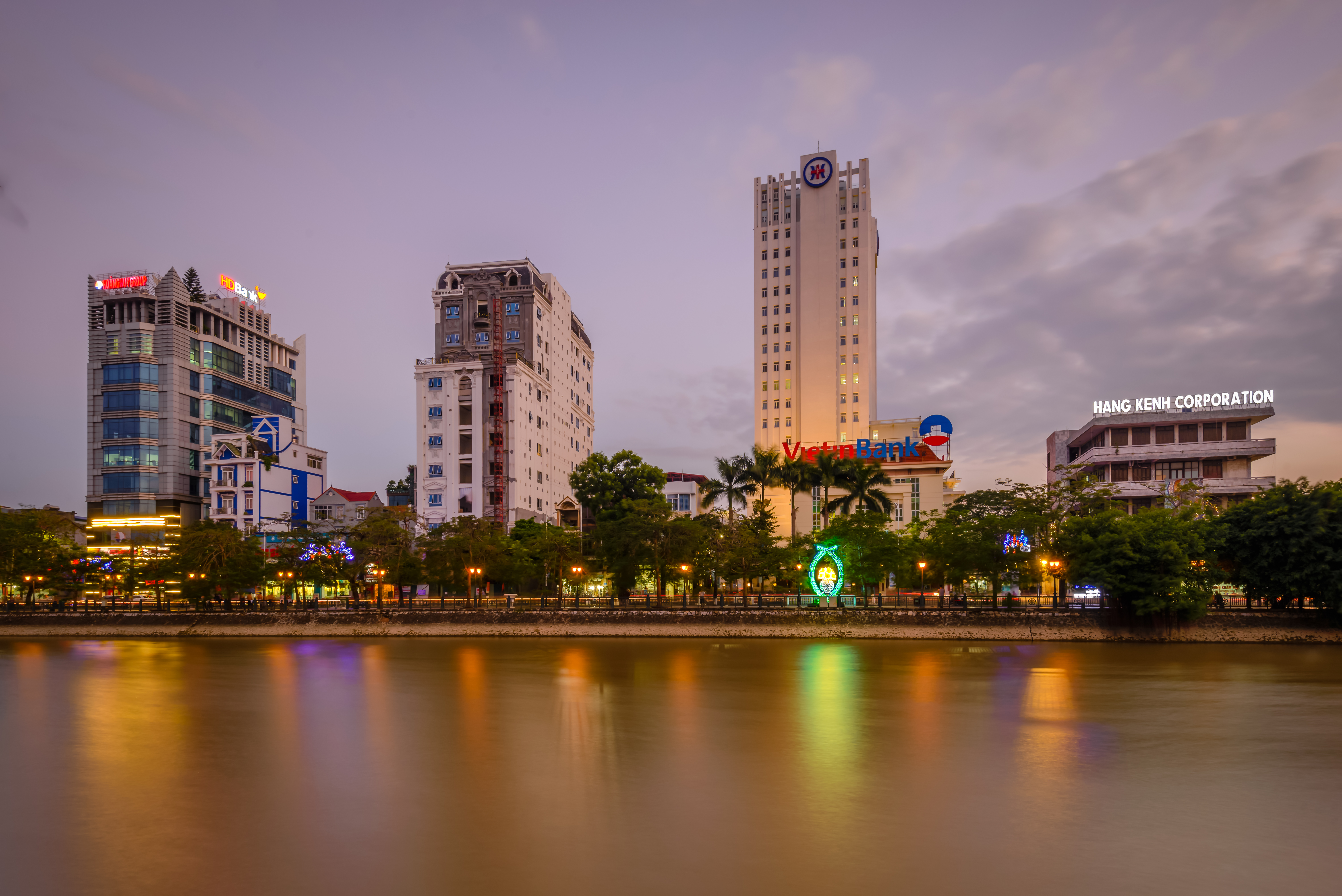 a body of water with buildings and trees