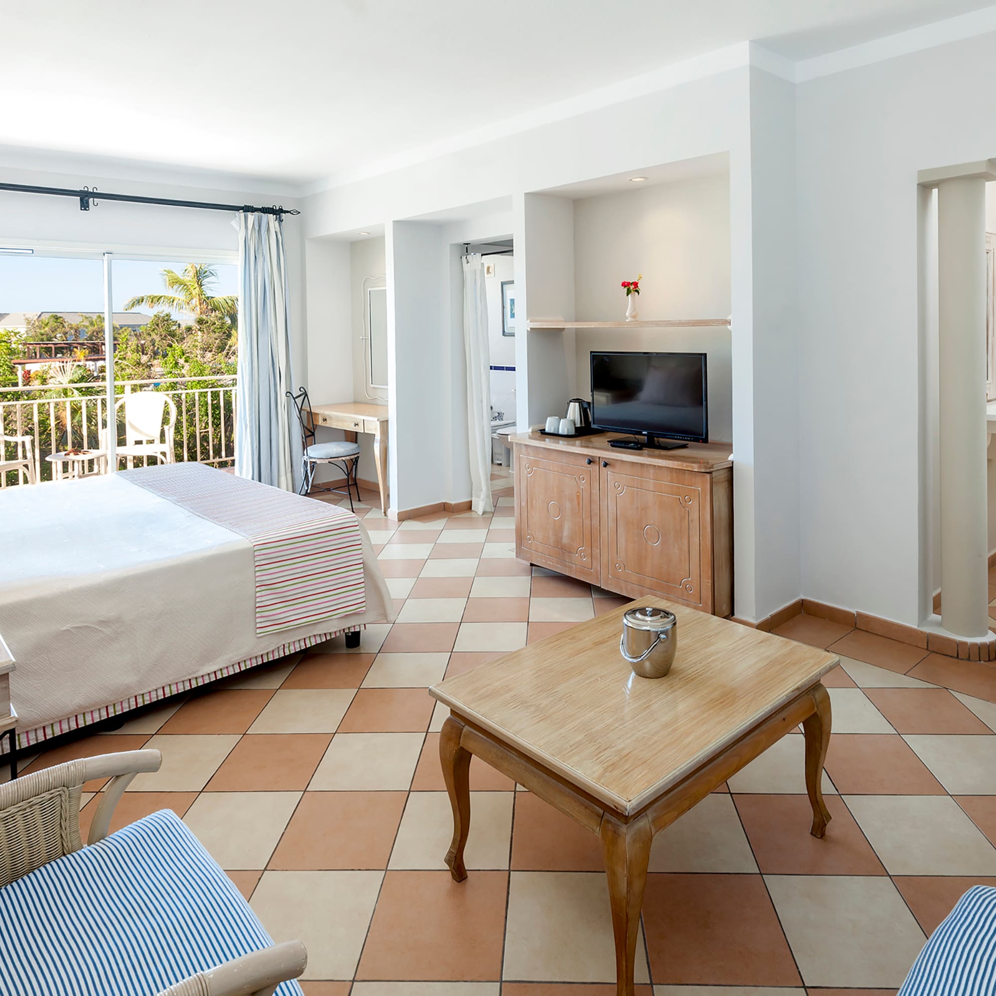 a room with a bed and a television