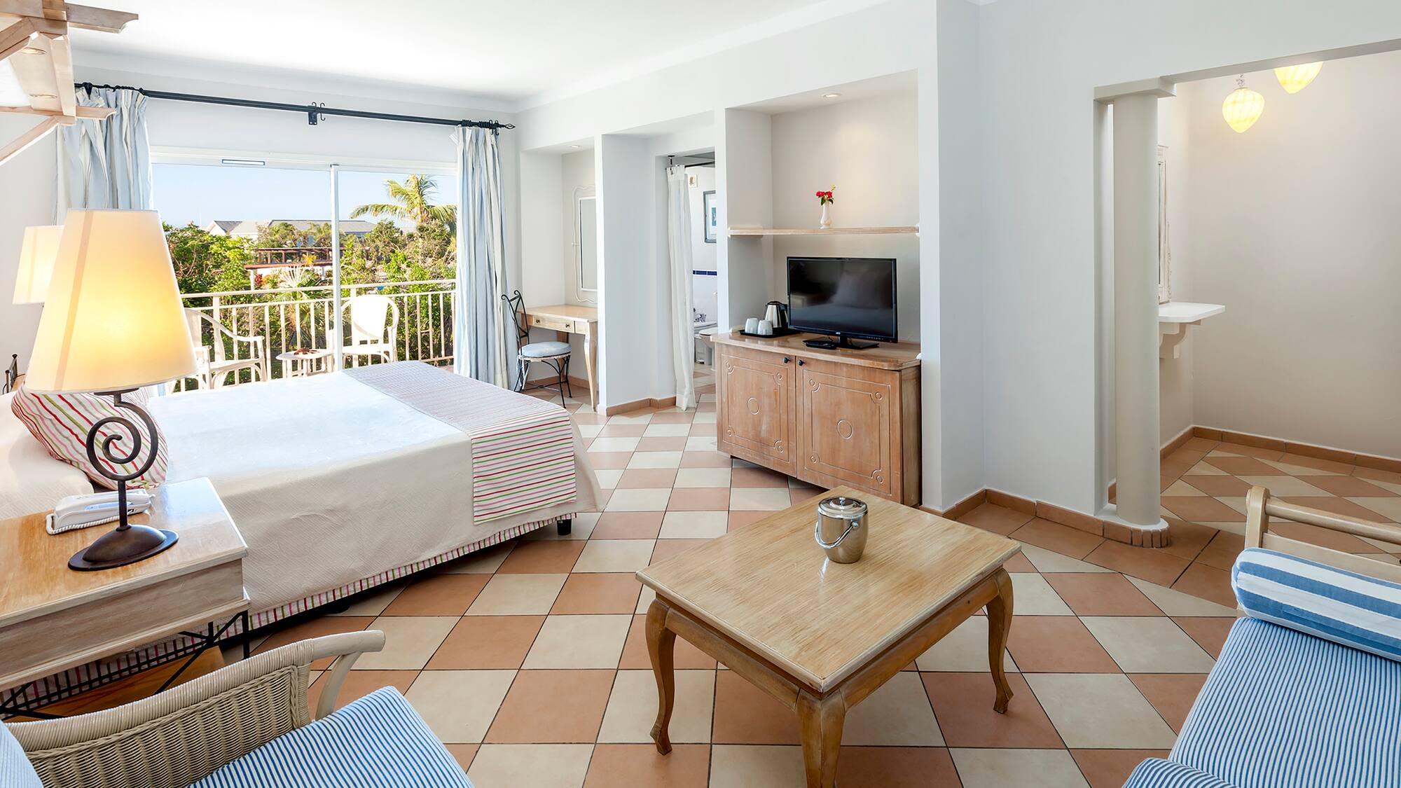 a room with a bed and a television