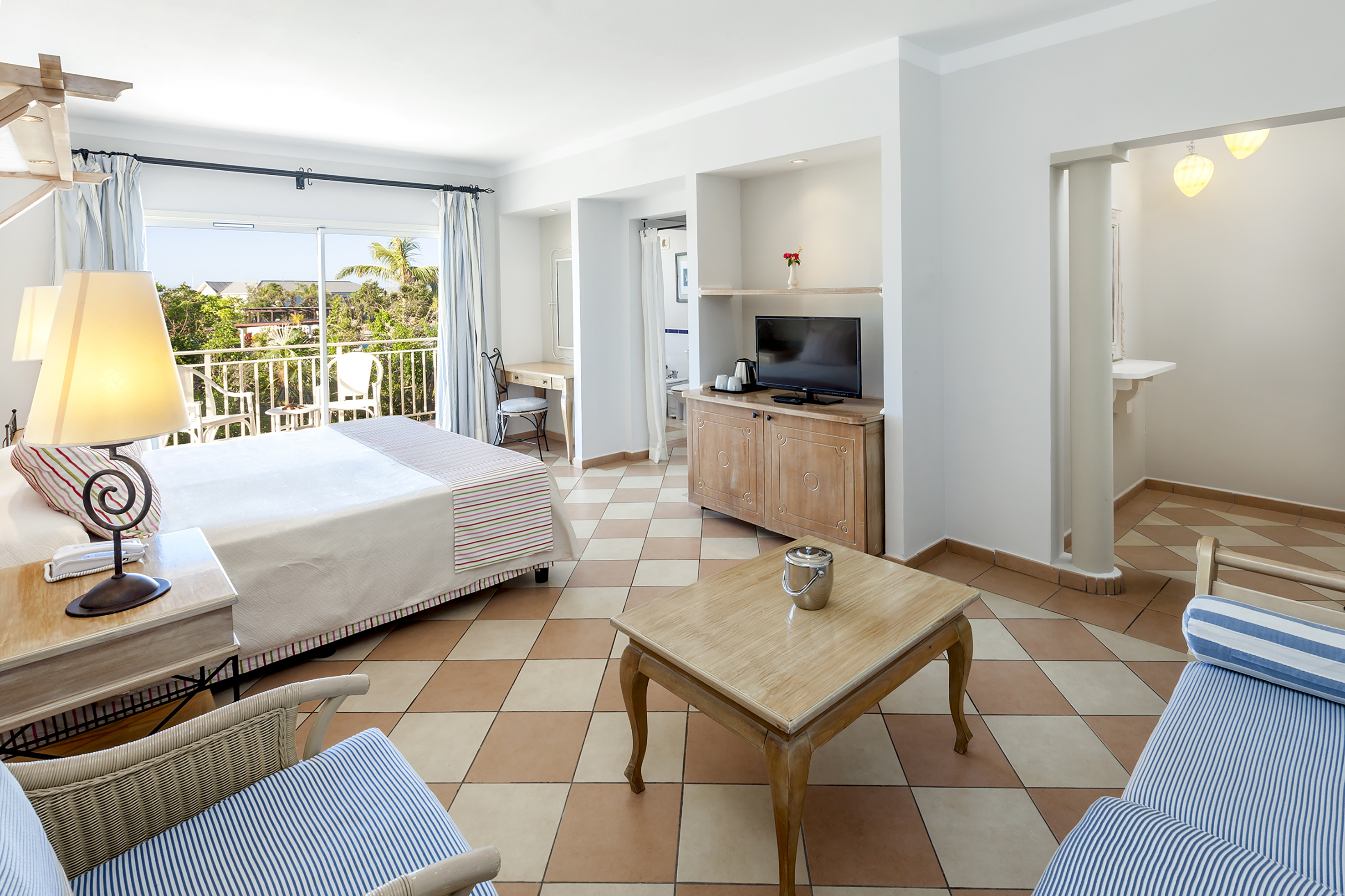 a room with a bed and a television