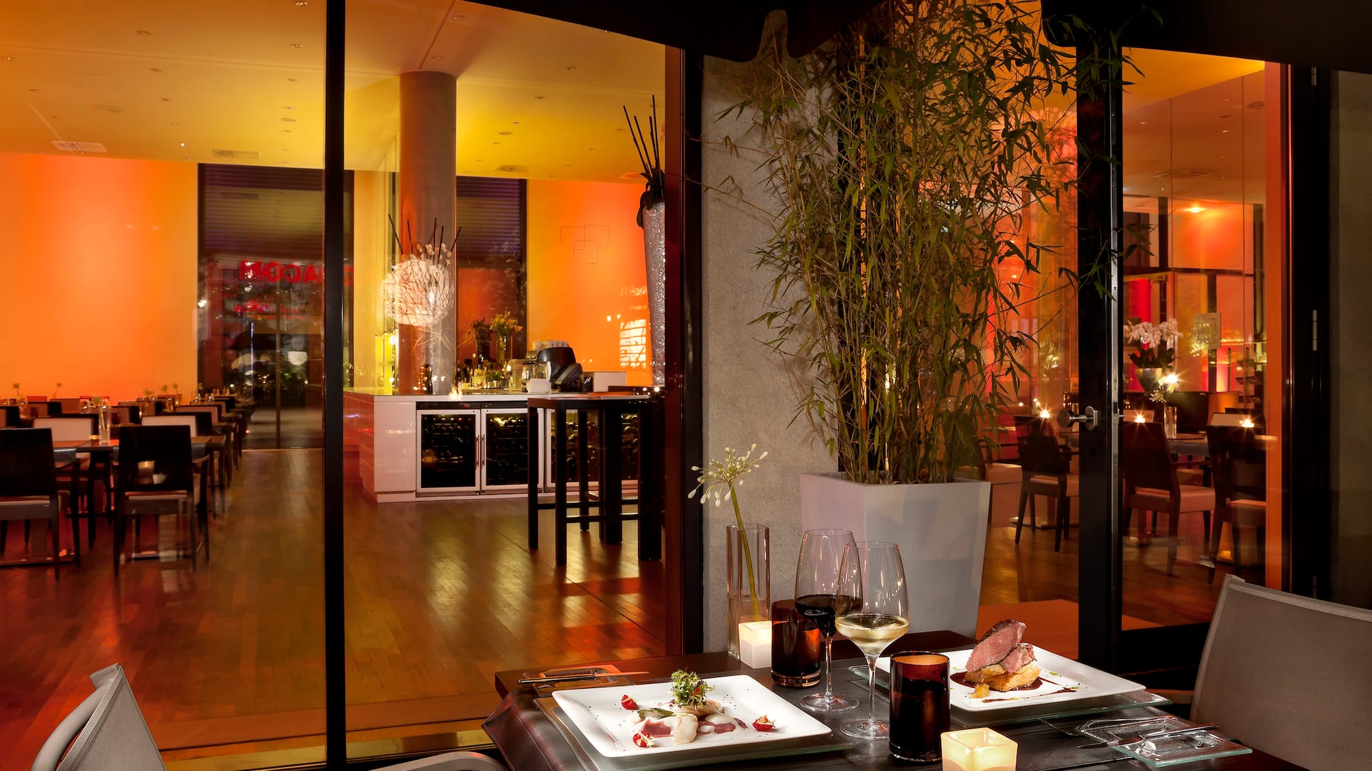 a table with plates of food and wine glasses on it