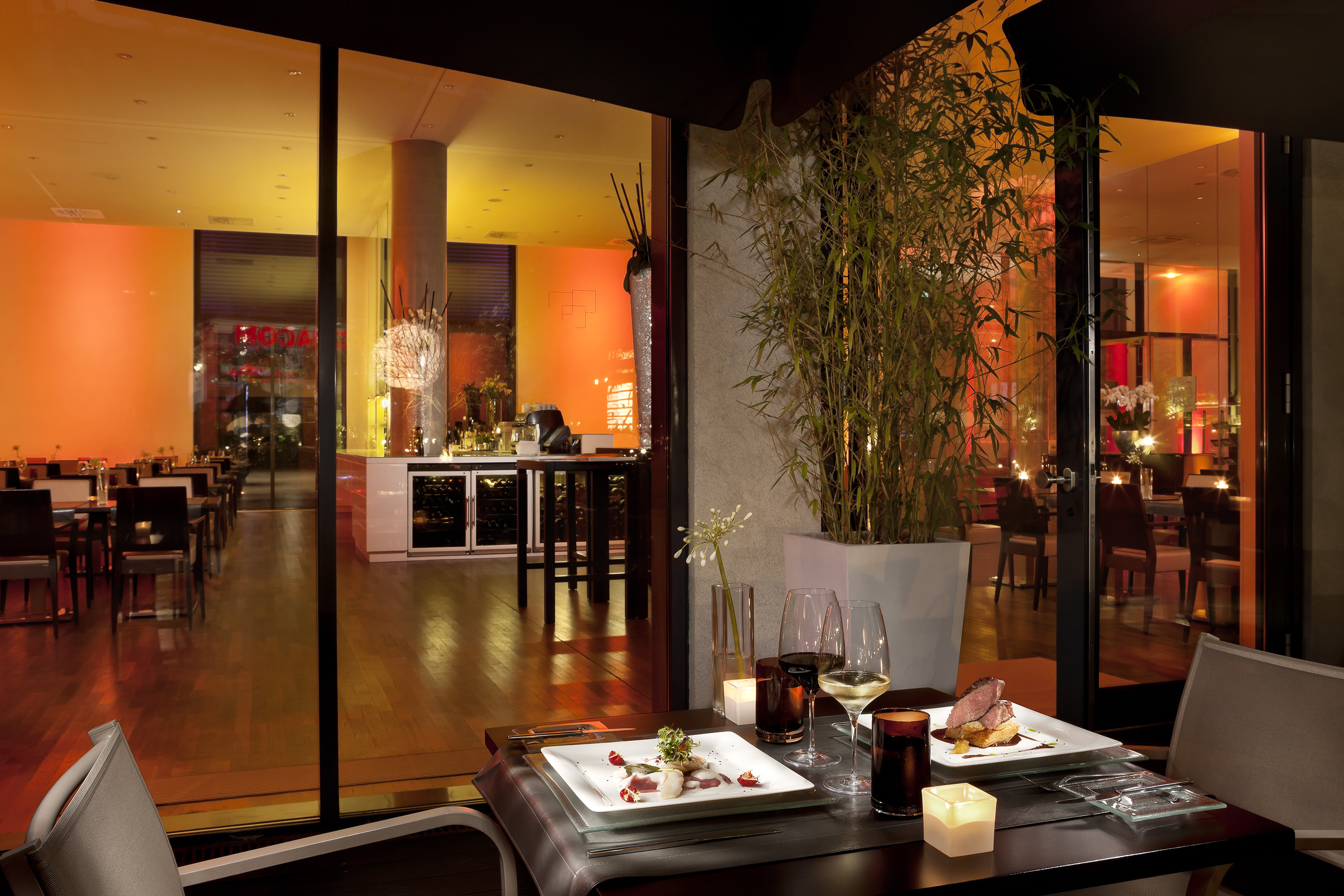 a table with plates of food and wine glasses on it