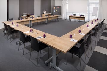 a conference room with tables and chairs