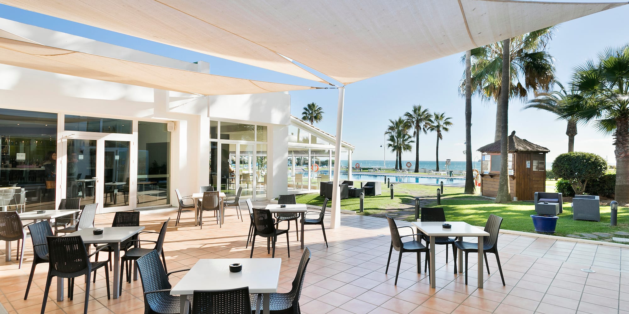 a patio with tables and chairs