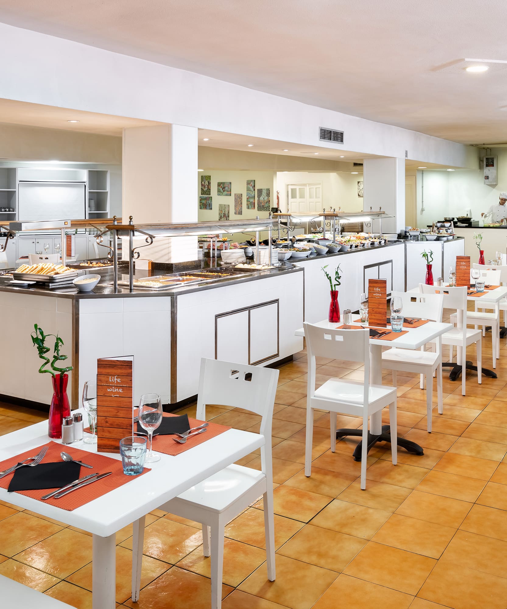 a restaurant with white tables and chairs