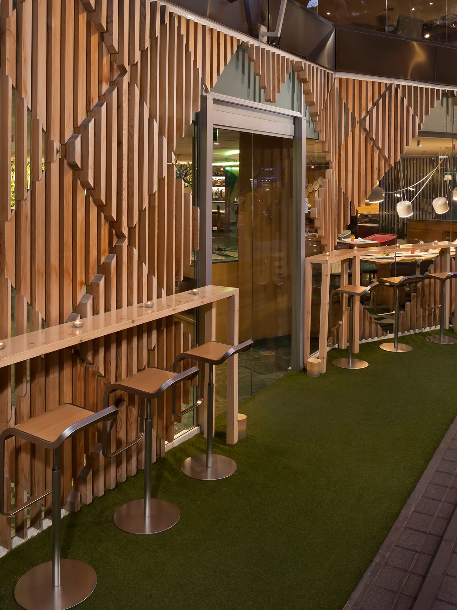 a room with a wall and tables and chairs.