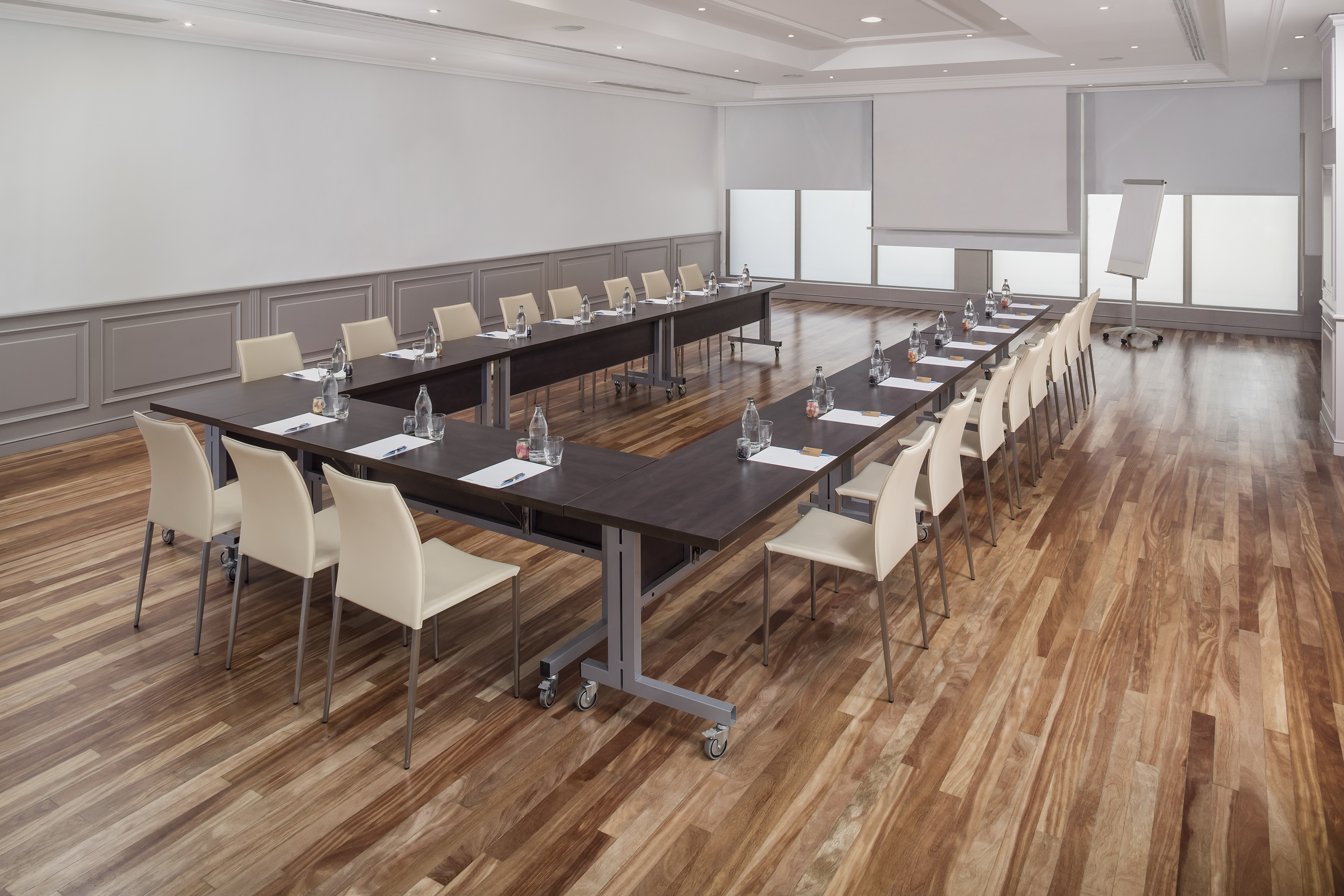 a room with long tables and chairs